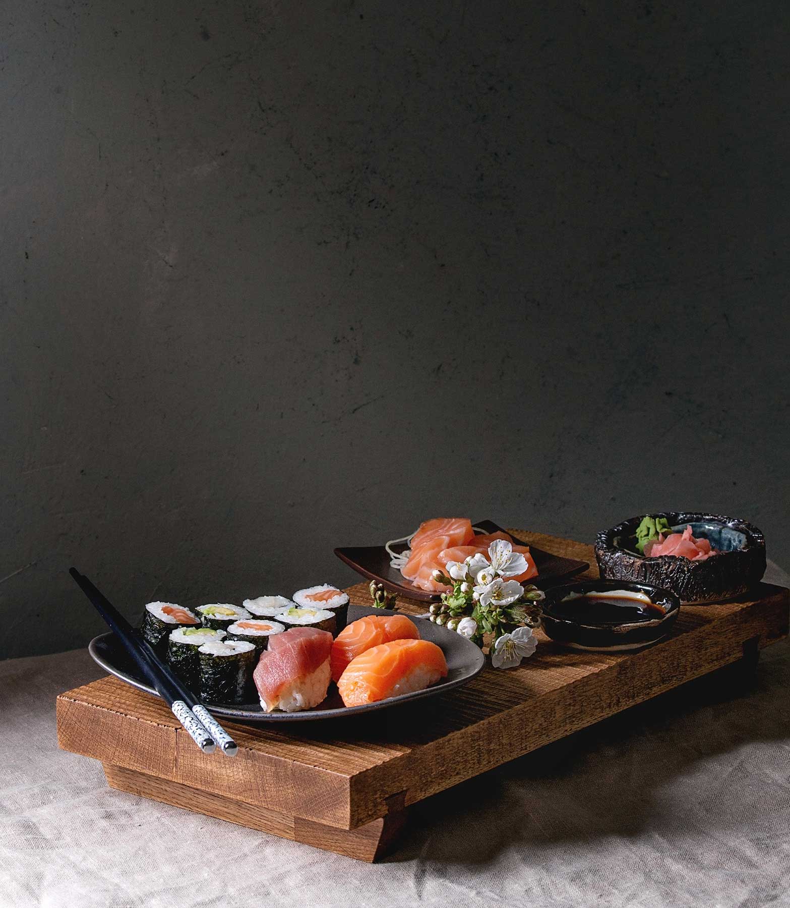 A quiet table set with sushi and sake before service